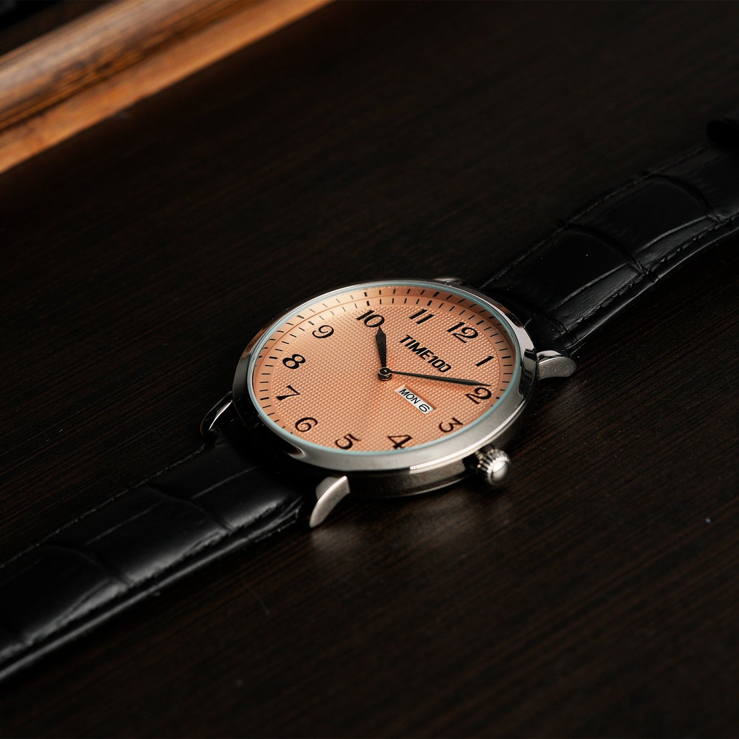 Close-up of the minimalist white dial featuring a dual English and calendar without a second hand Brown - Time100