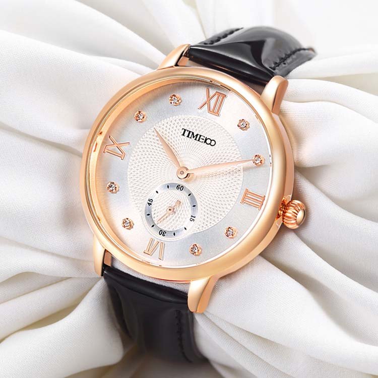 Close-up of the pure white embossed dial featuring 8 brilliant diamonds and classic Roman numerals Black - Time100