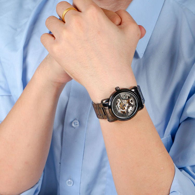 Professional man wearing the TIME100 industrial-inspired skeleton watch with a business suit Black - Time100