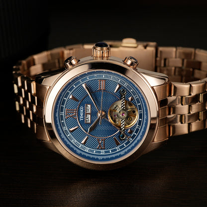 Close-up of TIME100 automatic watch face showing complex skeleton design, date, month, and week displays Gold Blue - Time100