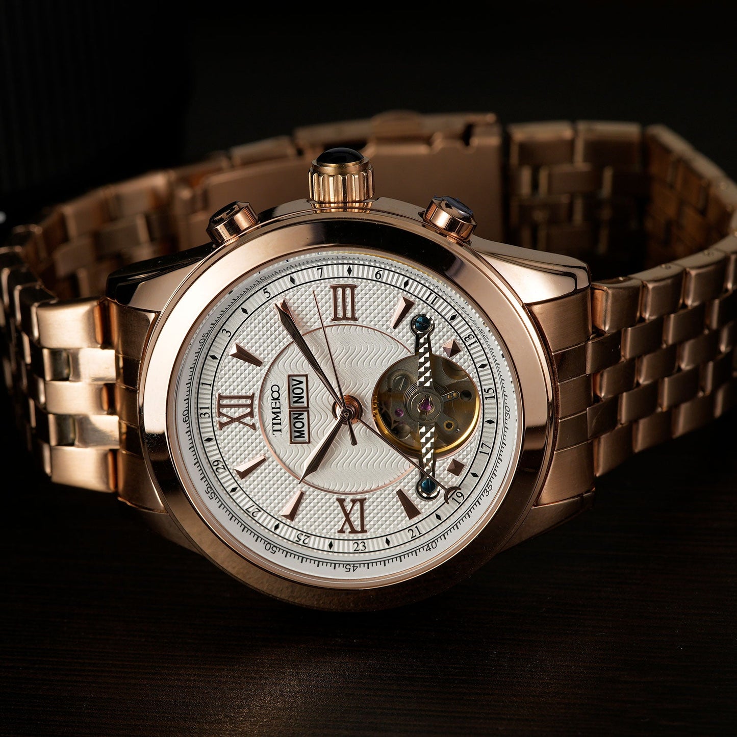 Close-up of TIME100 automatic watch face showing complex skeleton design, date, month, and week displays Gold White - Time100