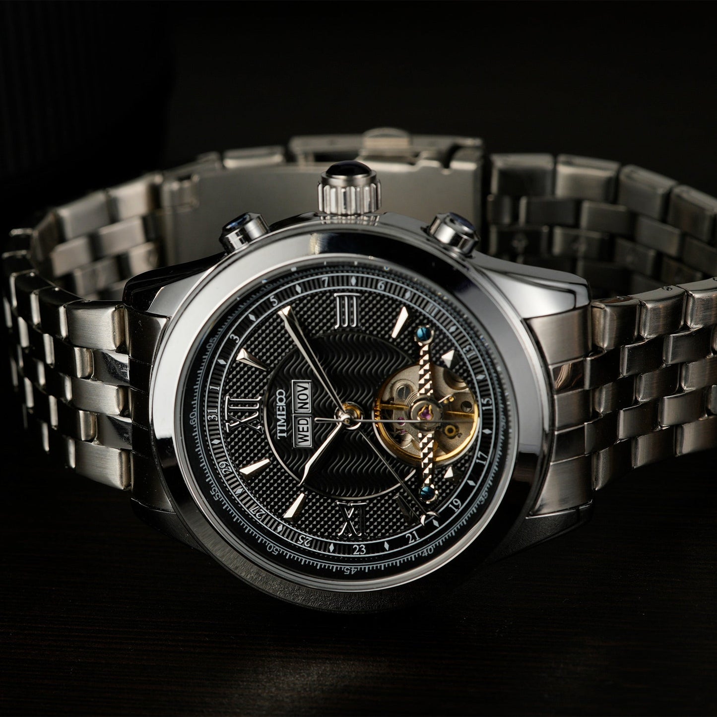 Close of TIME100 automatic watch face showing complex skeleton design, date, month, and week displays Silver Black - Time100