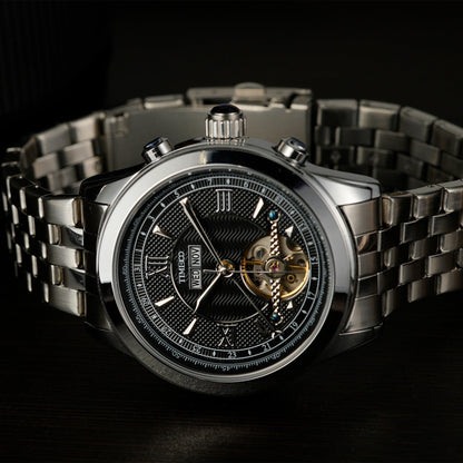 Close of TIME100 automatic watch face showing complex skeleton design, date, month, and week displays Silver Black - Time100