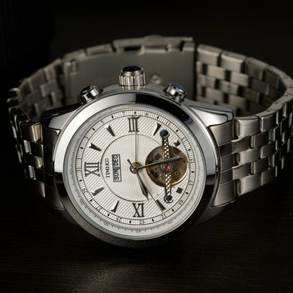 Close of TIME100 automatic watch face showing complex skeleton design, date, month, and week displays Silver White - Time100