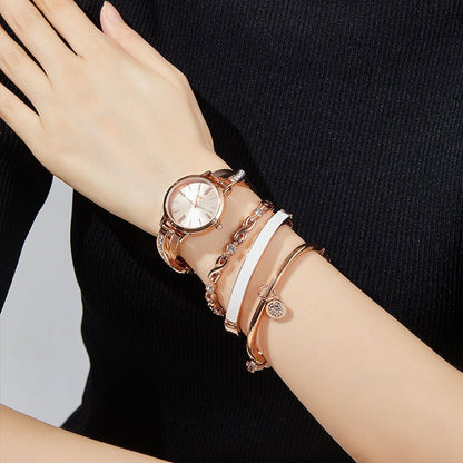 Detail of the included white enamel bangle, crystal charm bangle, and X-shaped link bracelet Rose Gold - Time100