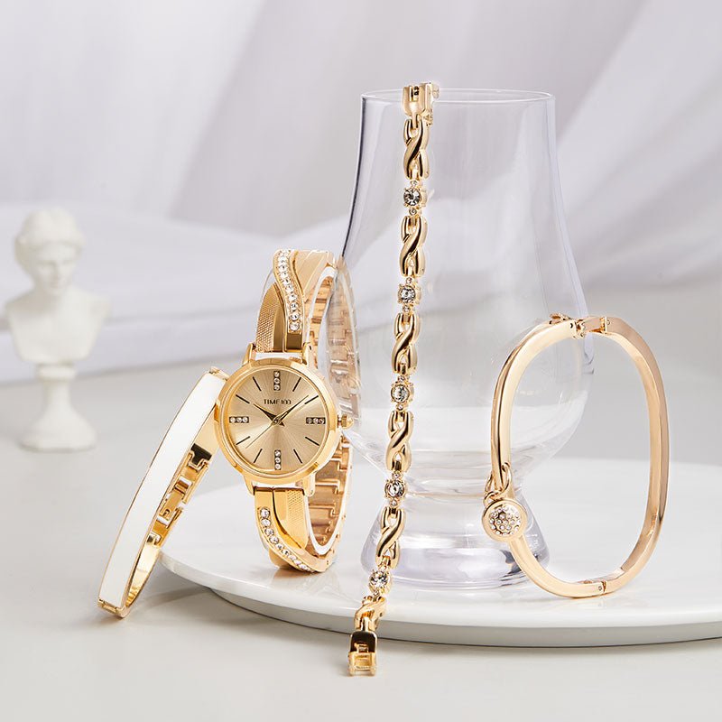 Detail of the included white enamel bangle, crystal charm bangle, and X-shaped link bracelet Gold - Time100