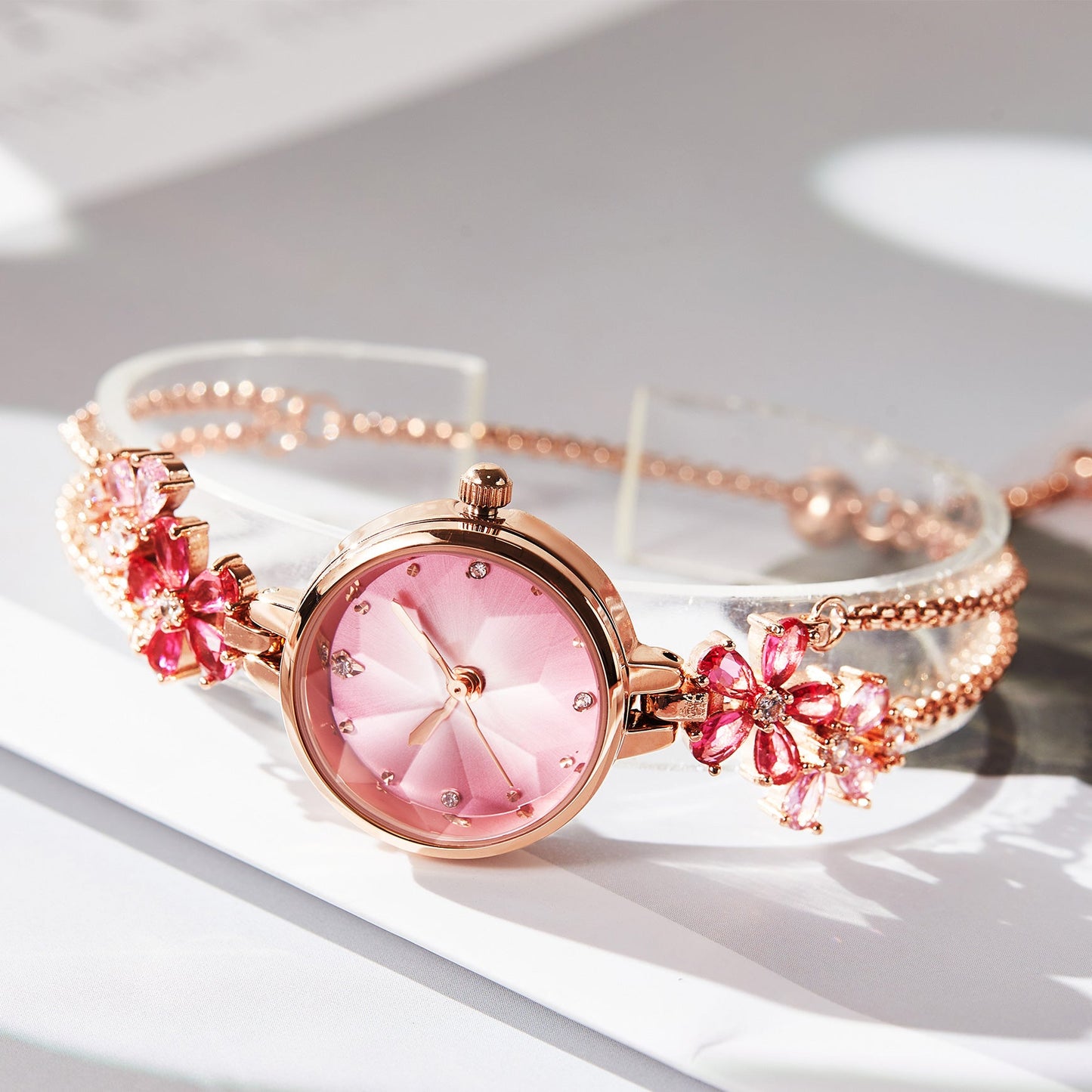 Close-up of TIME100 Stella watch showing the unique cut mirror crystal lens and periwinkle flower dial Red - Time100