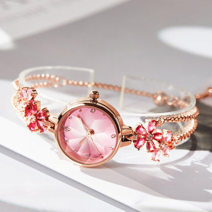 Close-up of TIME100 Stella watch showing the unique cut mirror crystal lens and periwinkle flower dial Red - Time100