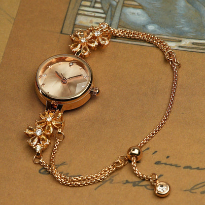 Woman wearing the TIME100 Stella periwinkle flower dial watch as a spring fashion statement piece Gold - Time100
