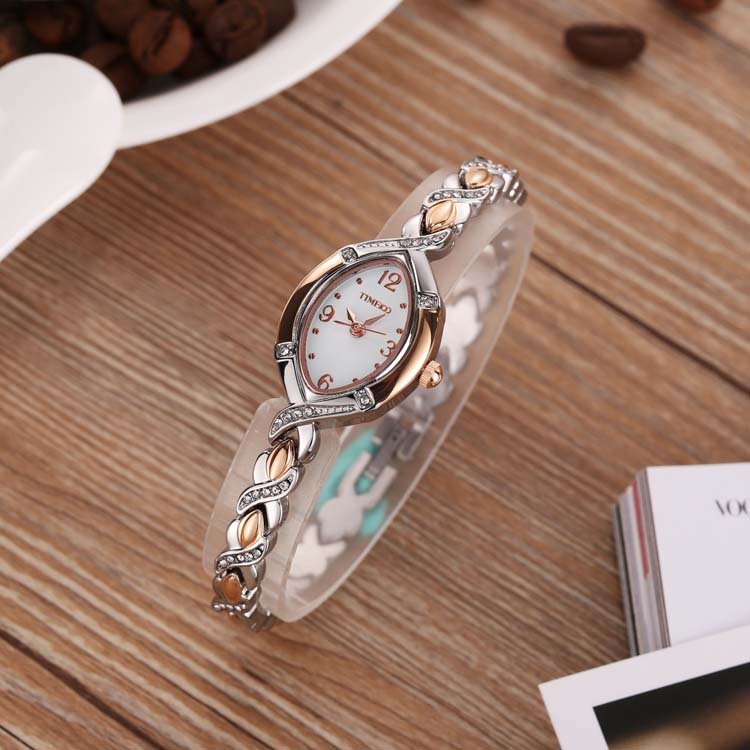 Sophisticated layered look with the TIME100 Soho rose gold-tone oval watch and matching bracelets on wrist Silver - Time100