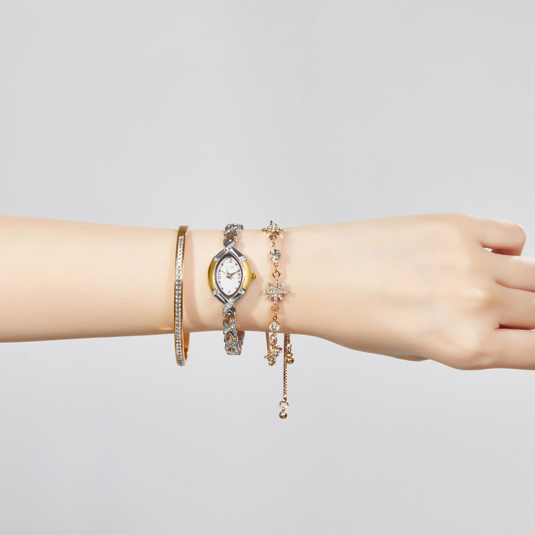 Woman's wrist showing a sophisticated layered look with the TIME100 Chelsea watch and jewelry bracelets Silver - Time100