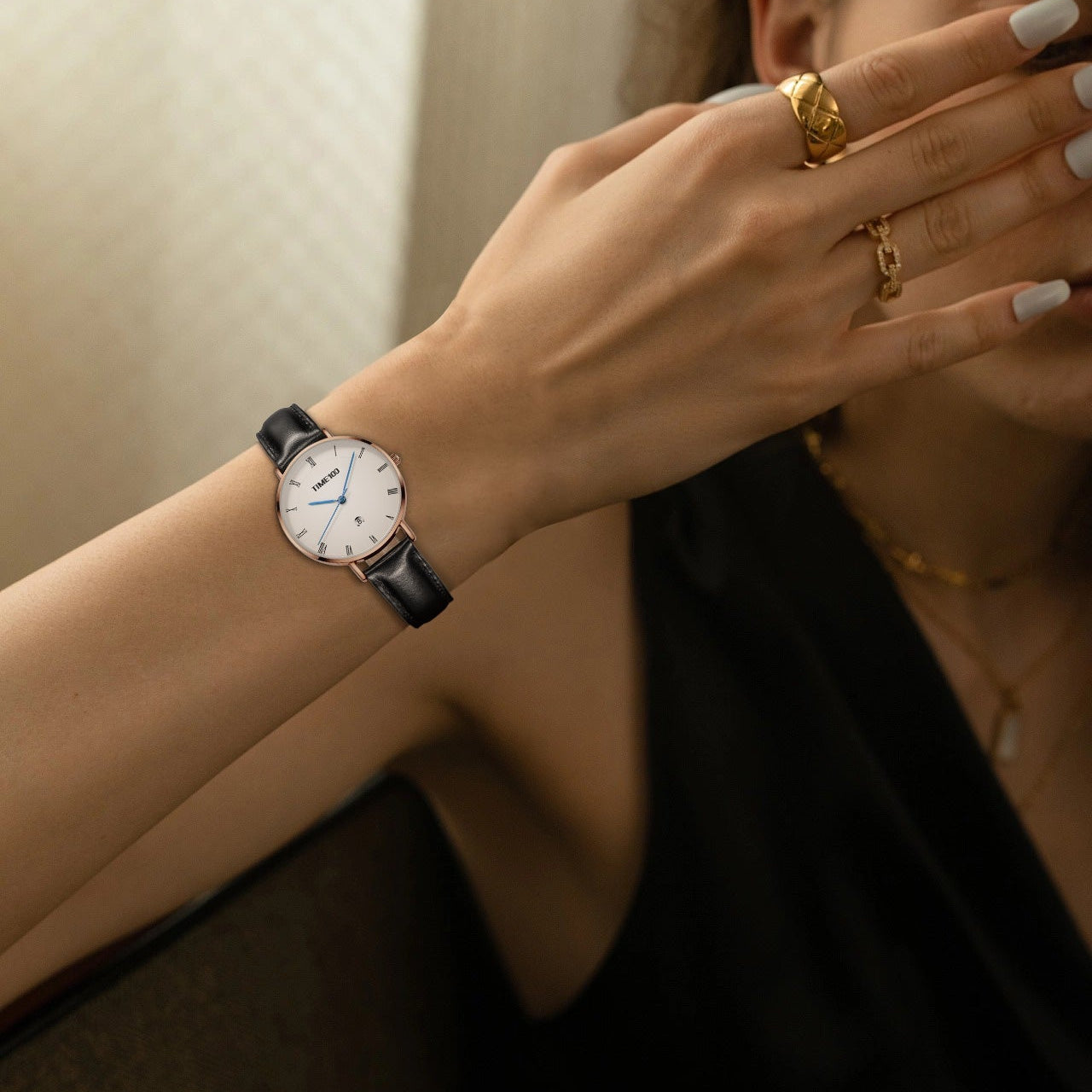 Close-up of the tailored white dial showing the sweep second hand, blue hands, and small date window Brown - Time100