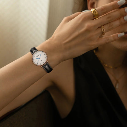 Close-up of the tailored white dial showing the sweep second hand, blue hands, and small date window Brown - Time100