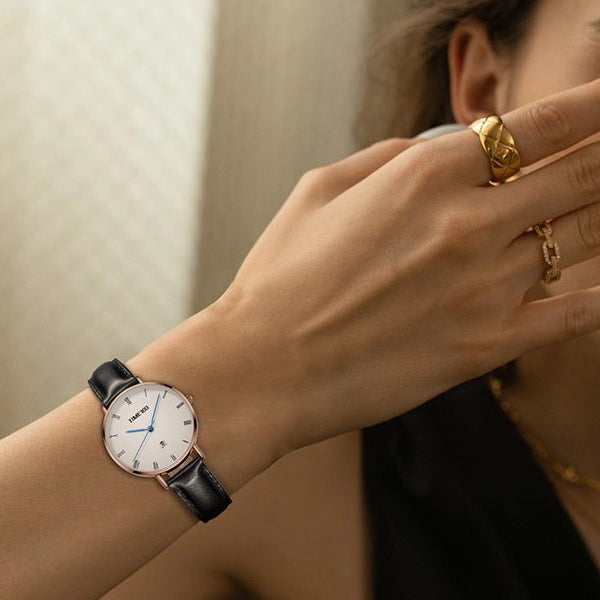 Close-up of the tailored white dial showing the sweep second hand, blue hands, and small date window  - Time100